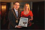 Head of Victims Services Irene Sherry receiving a certificate from the Mayor of Belfast 'in recognition of the contribution to the promotion of positive mental health, suicide prevention and wellbeing.